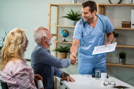 happy-healthcare-worker-mature-couple-greeting-his-office-men-are-shaking-hands-1