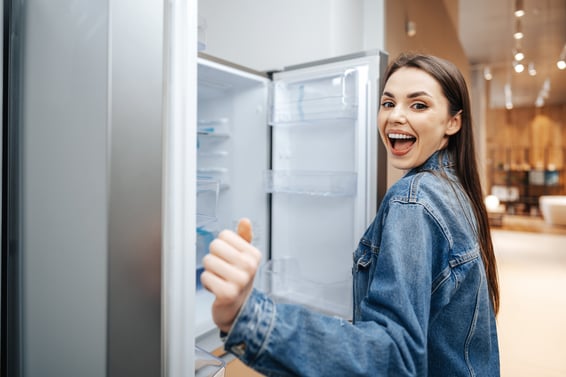 young-attractive-woman-choosing-refrigerator-hypermarket
